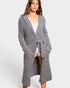 Woman wearing a long gray cardigan on a white background