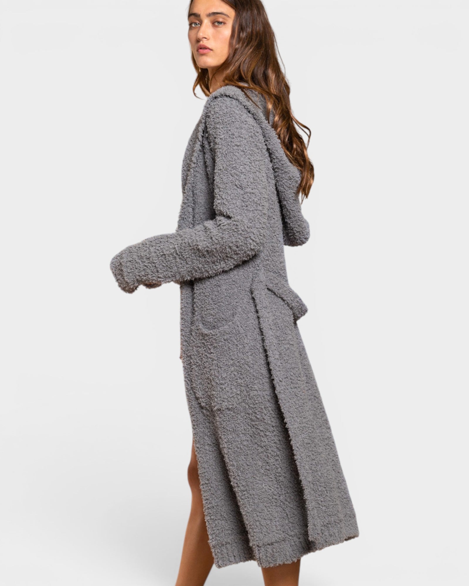 Woman wearing a gray robe on a white background