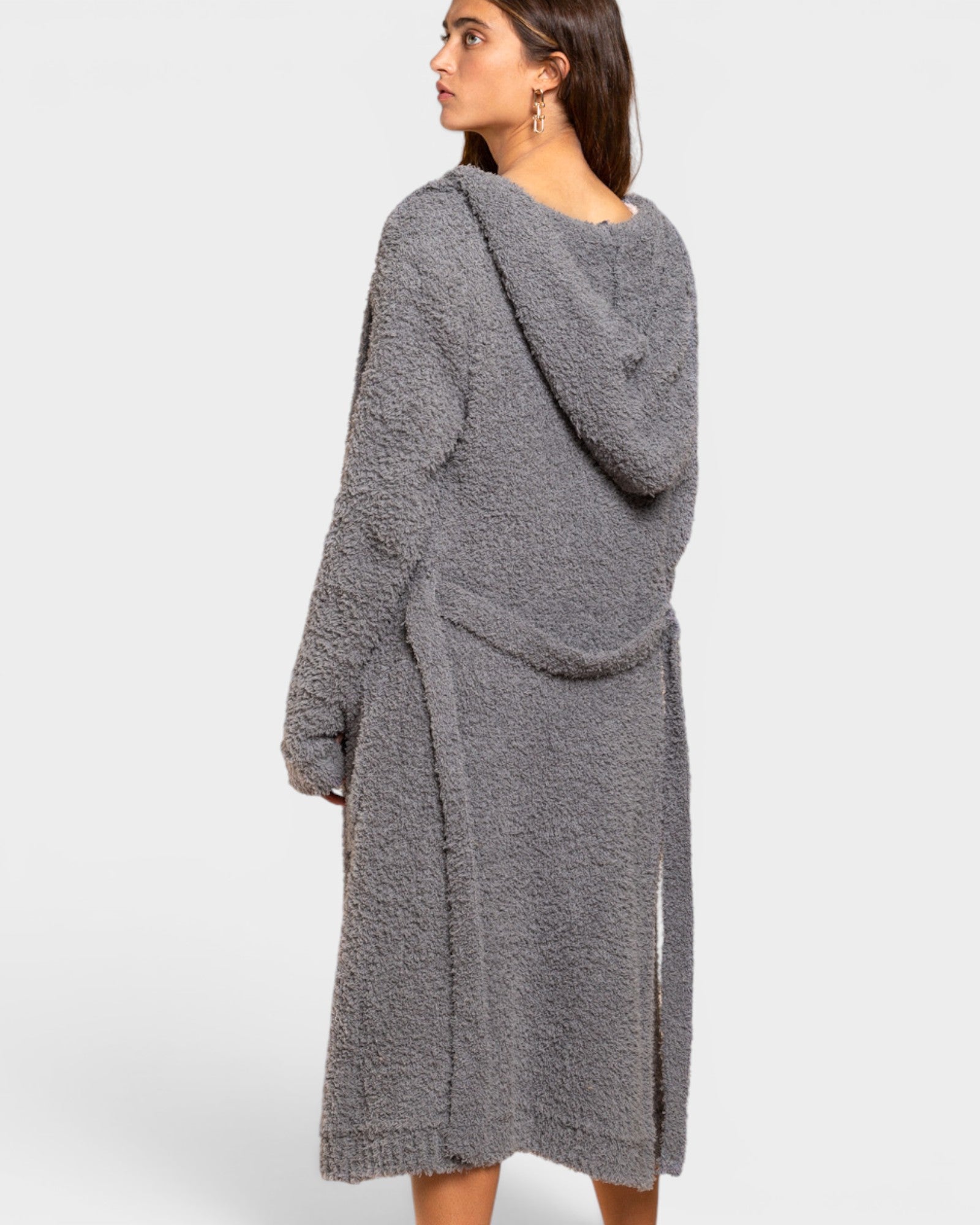 Woman wearing a gray hooded cardigan on a white background