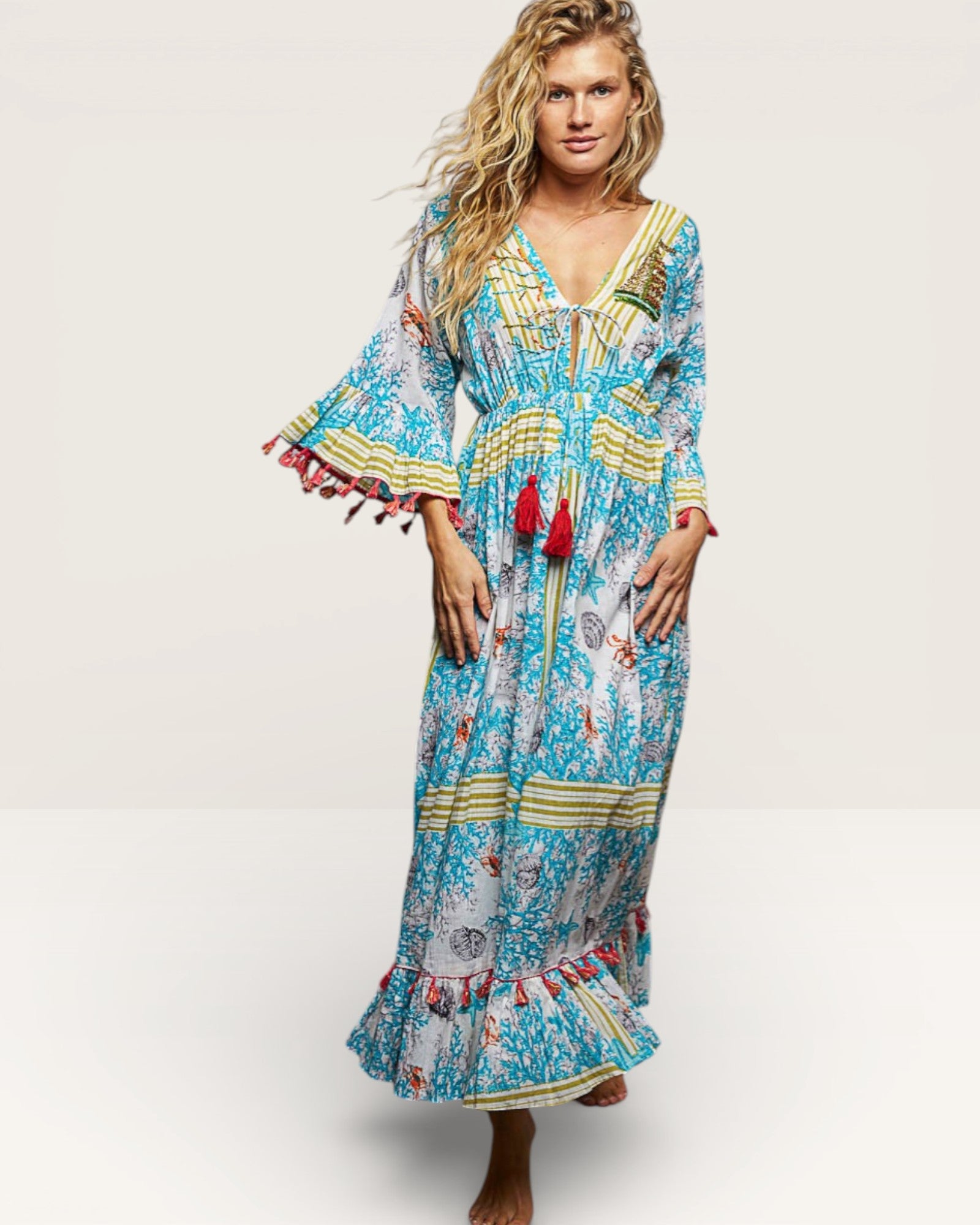 Woman wearing a colorful patterned dress on a white background