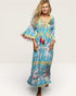 Woman wearing a colorful patterned dress on a white background