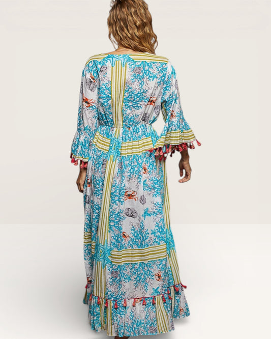 Woman wearing a colorful floral dress with ruffled sleeves on a white background