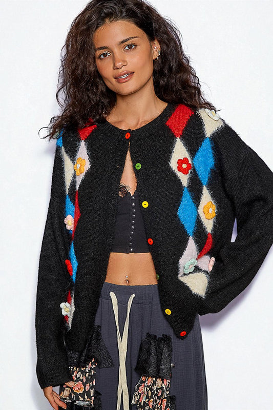 Woman wearing a colorful argyle cardigan with a white background