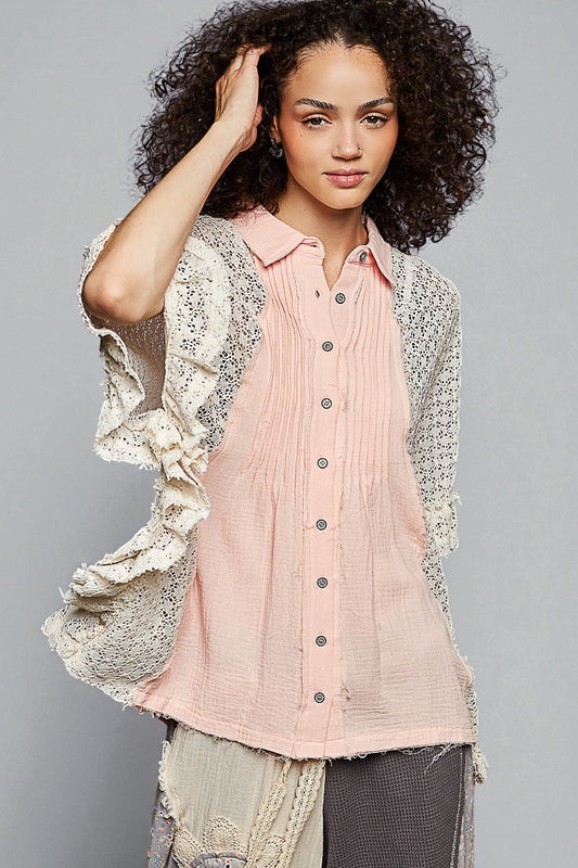 Woman wearing a light pink button-up shirt with a textured cardigan against a gray background