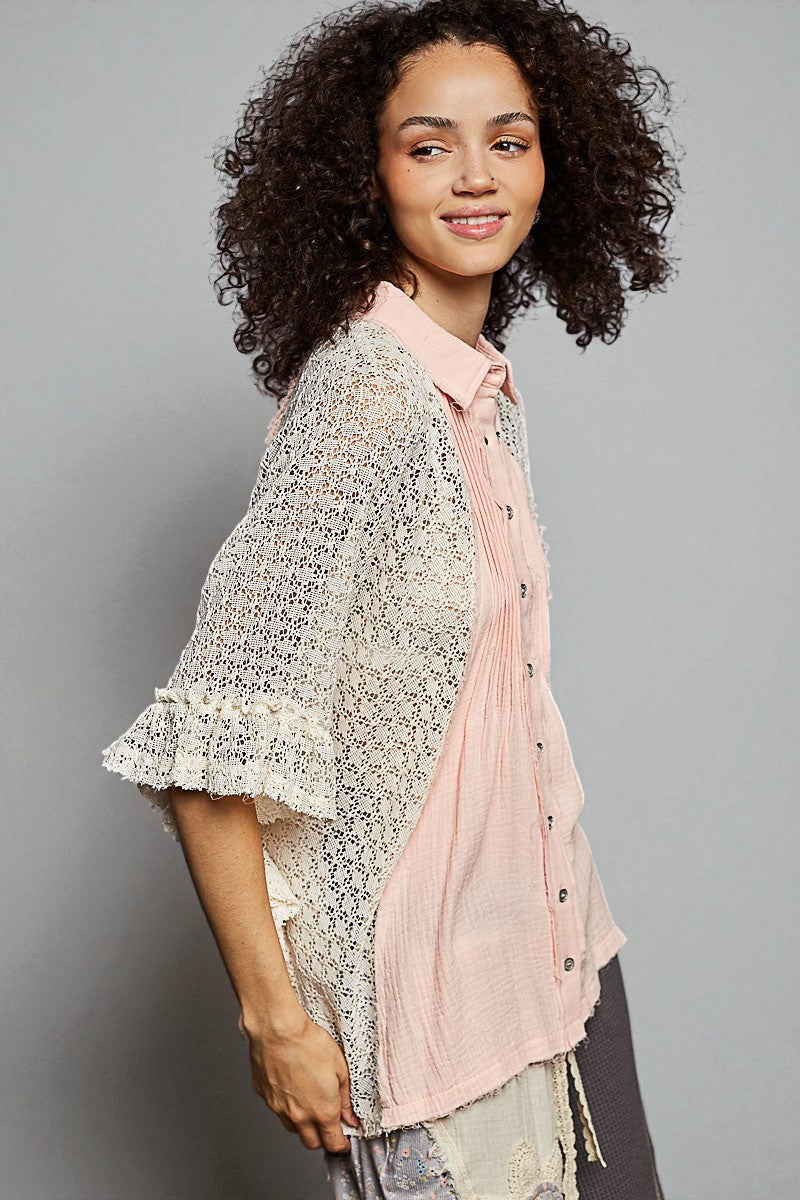 Woman wearing a light pink blouse and patterned cardigan against a gray background