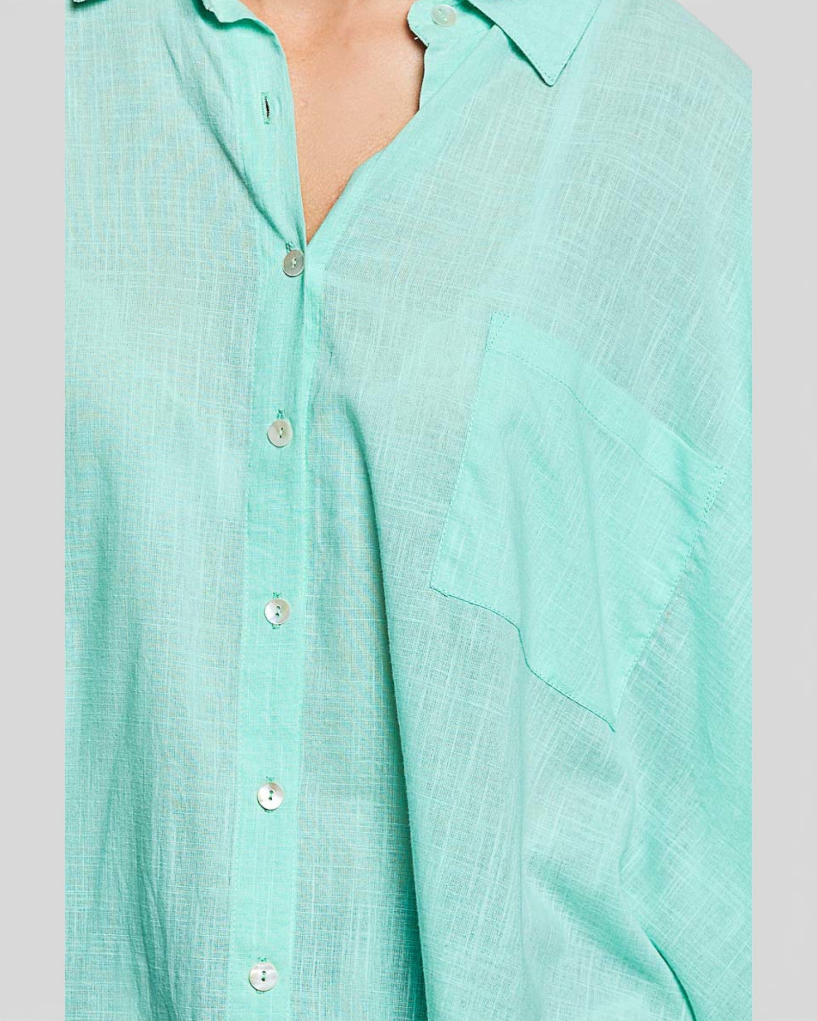 Light blue button-up shirt on a gray background