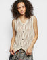 Woman wearing a beige knitted vest against a plain background