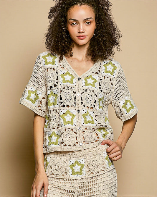 Woman wearing a crochet outfit with star patterns on a beige background