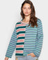 Woman wearing a colorful striped shirt against a plain background