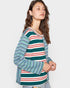 Woman wearing a colorful striped shirt on a plain background