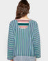 Woman wearing a colorful striped shirt with a plain background