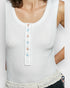 White tank top with colorful buttons worn by a person
