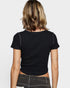 Person wearing a black t-shirt on a plain background