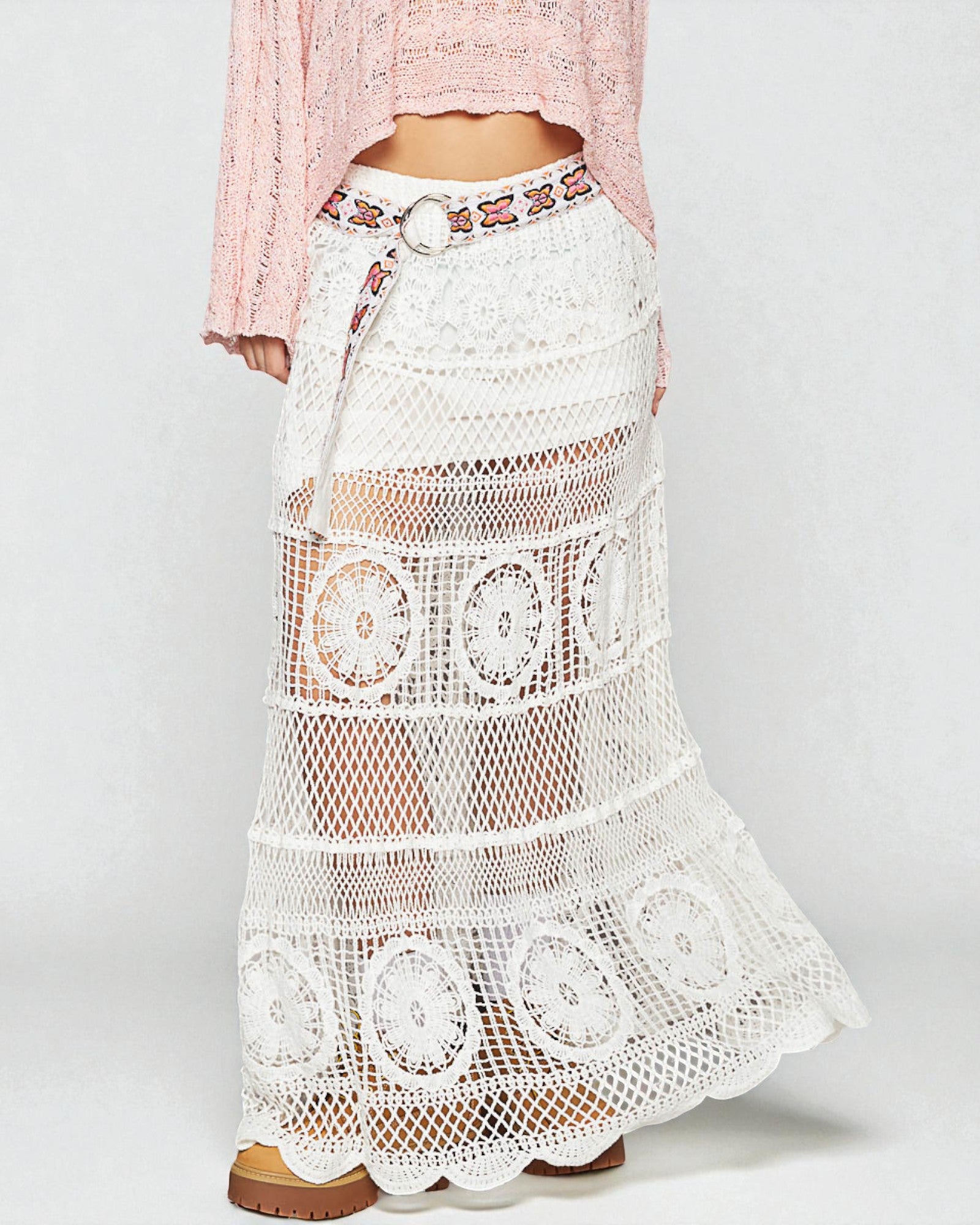 White crochet skirt with a pink top on a white background
