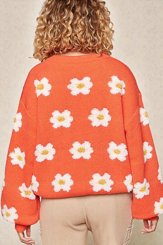 Suéter con hombros caídos y estampado de margaritas en color naranja sol