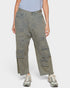 Person wearing distressed green cargo pants on a white background