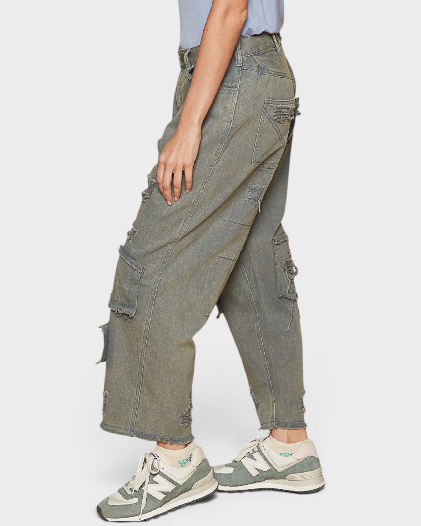 Person wearing oversized cargo pants and sneakers on a white background