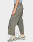 Person wearing oversized cargo pants and sneakers on a white background