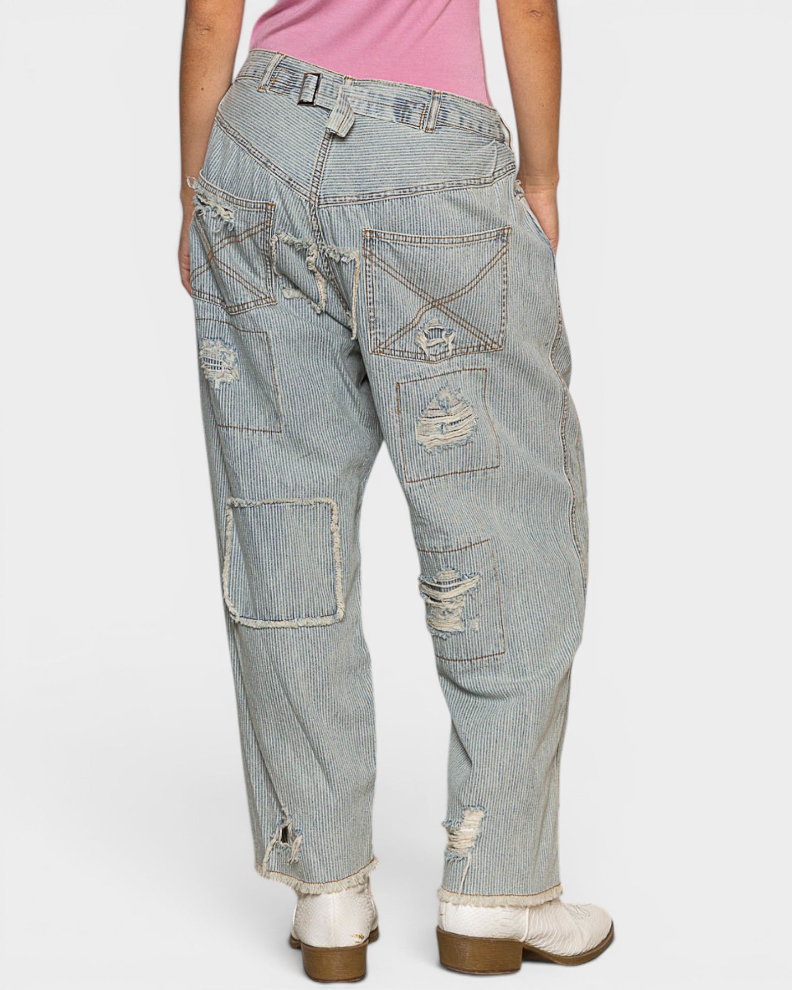 Light blue distressed jeans worn by a person on a white background