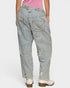 Light blue distressed jeans worn by a person on a white background