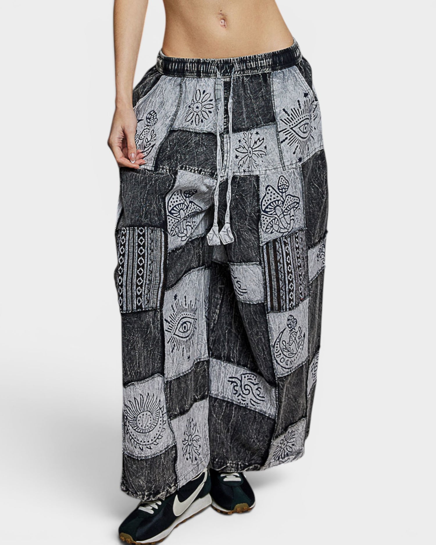 Patchwork pants with patterned design on a white background