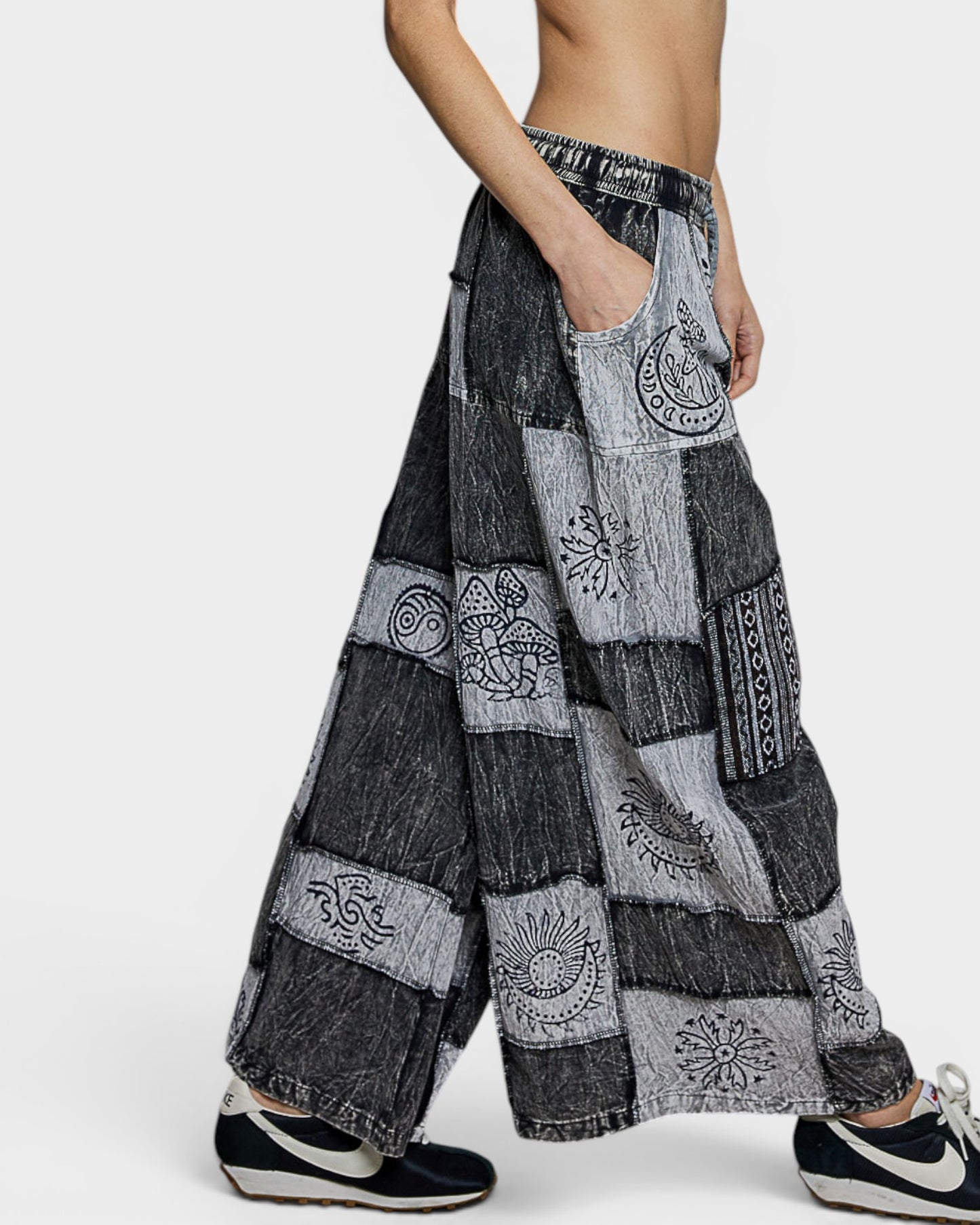 Patchwork wide-leg pants with embroidery on a white background