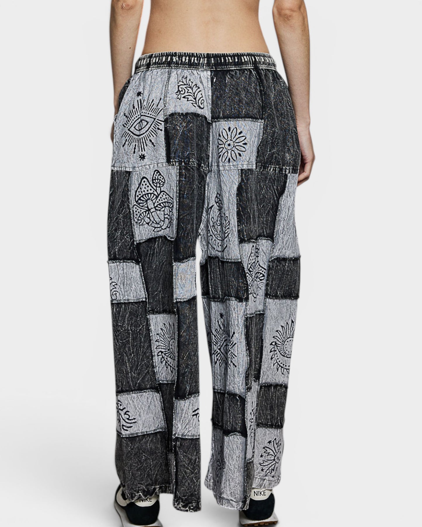 Patchwork pants with abstract patterns on a white background