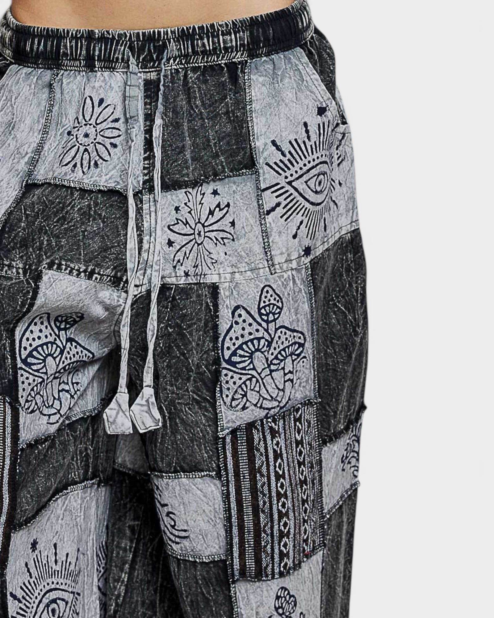 Patchwork pants with abstract patterns on a white background