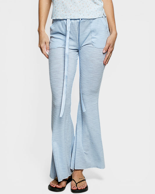 Light blue checkered pants with a belt worn by a person on a white background