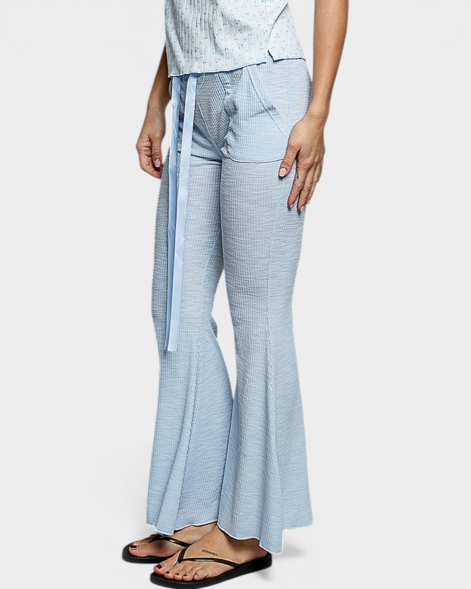 Light blue checkered pants worn by a person on a white background