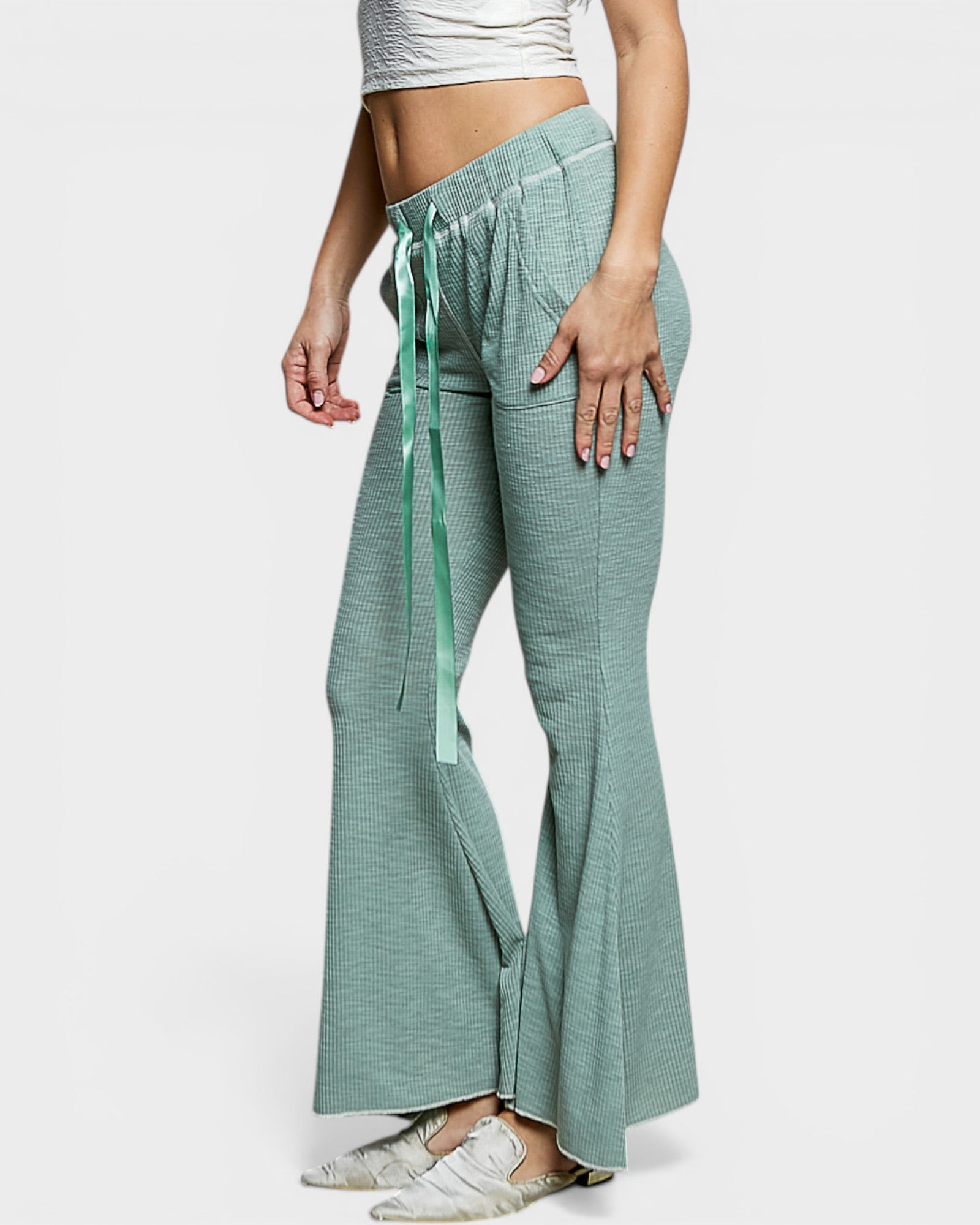 Green checkered pants worn by a person on a white background