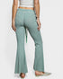 Green checkered flared pants worn by a person on a white background