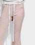Pink checkered pants with a white belt on a light gray background
