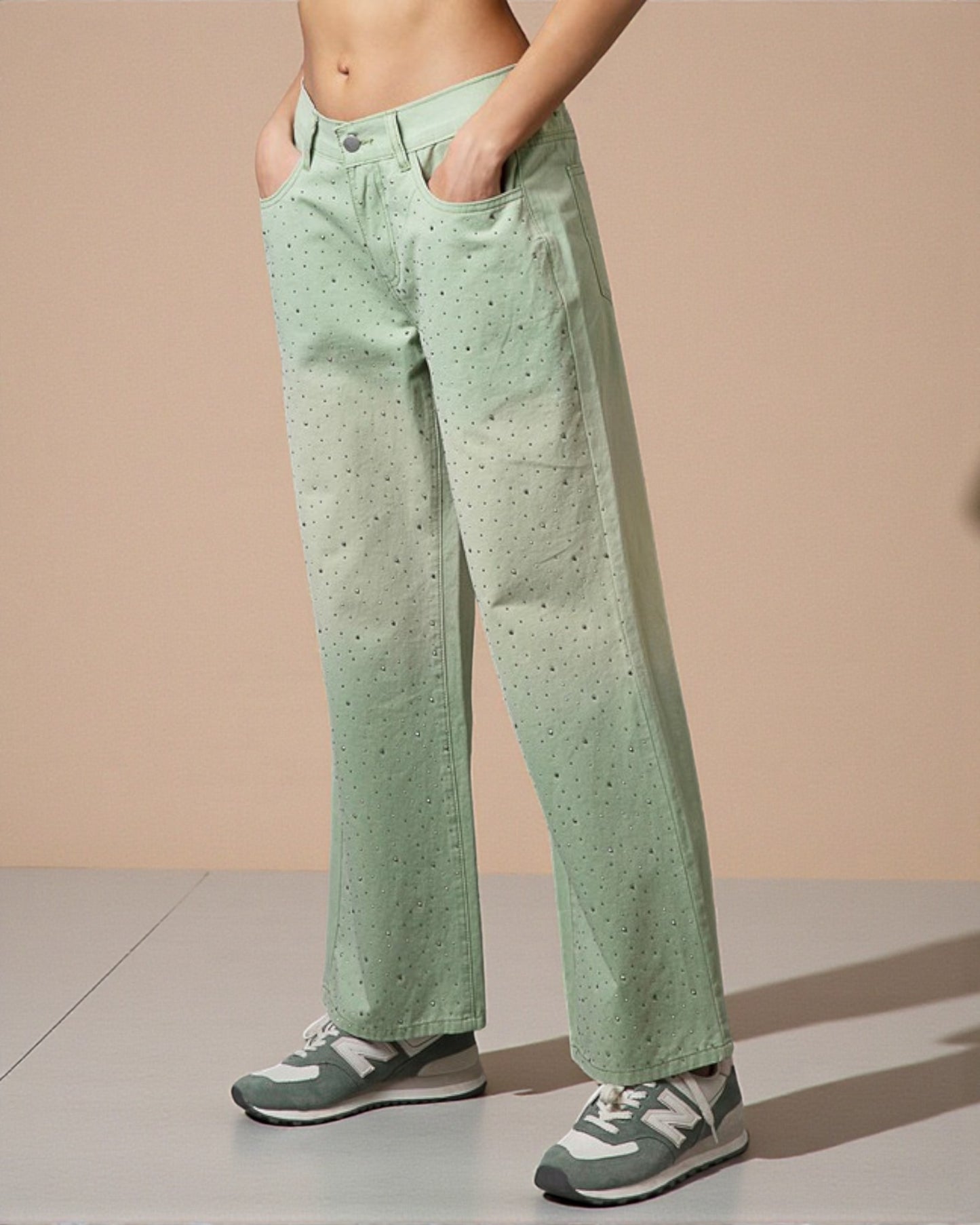 Person wearing light green pants with a subtle pattern on a beige background