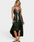 Woman wearing a black dress with floral embroidery on a white background