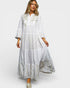Woman wearing a white dress with embroidery on a white background