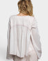 Light pink blouse worn by a person on a white background