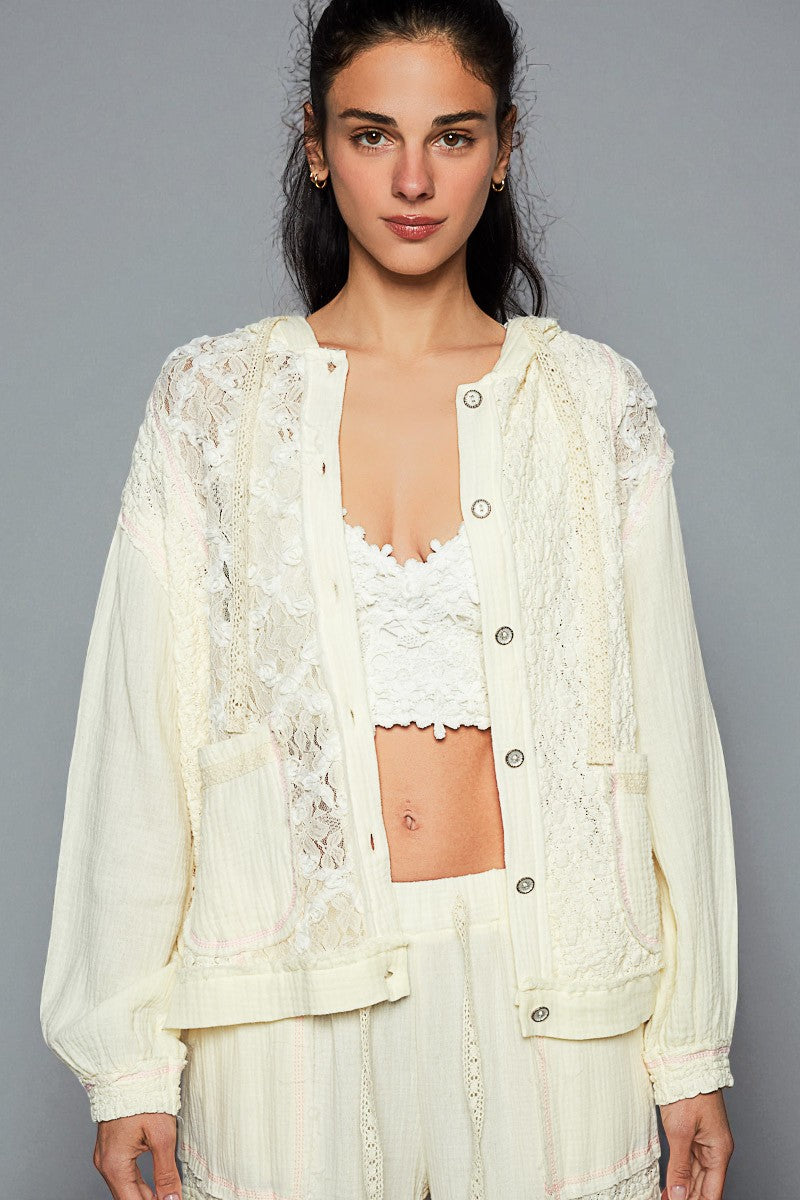 Woman wearing a white lace outfit against a gray background