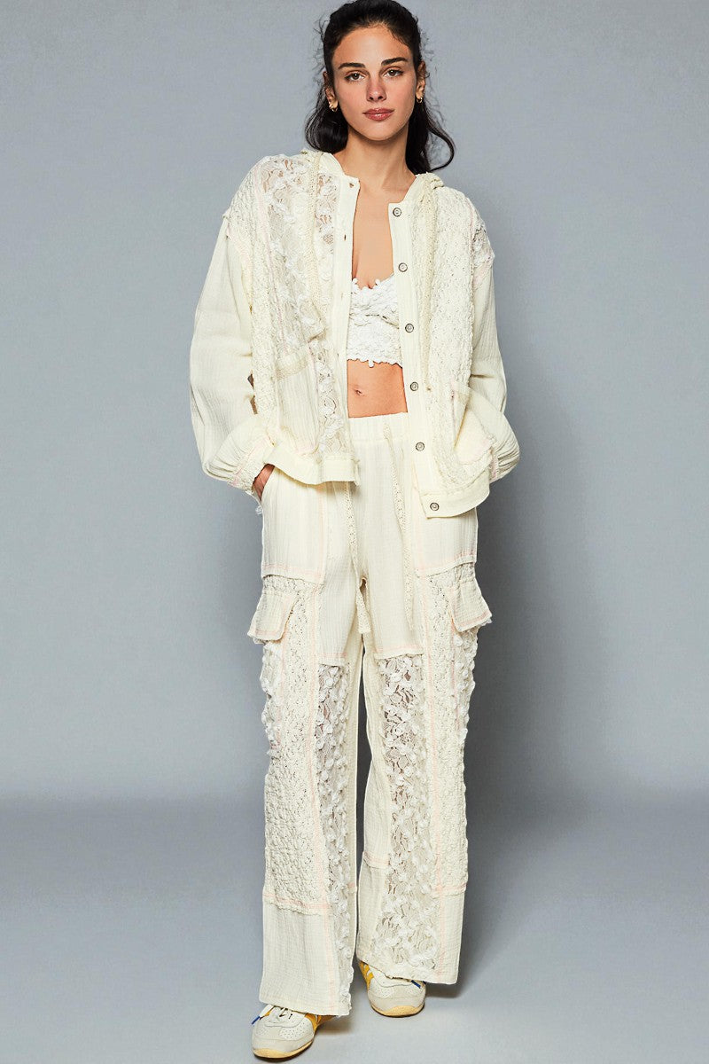 Woman wearing a white lace outfit against a gray background