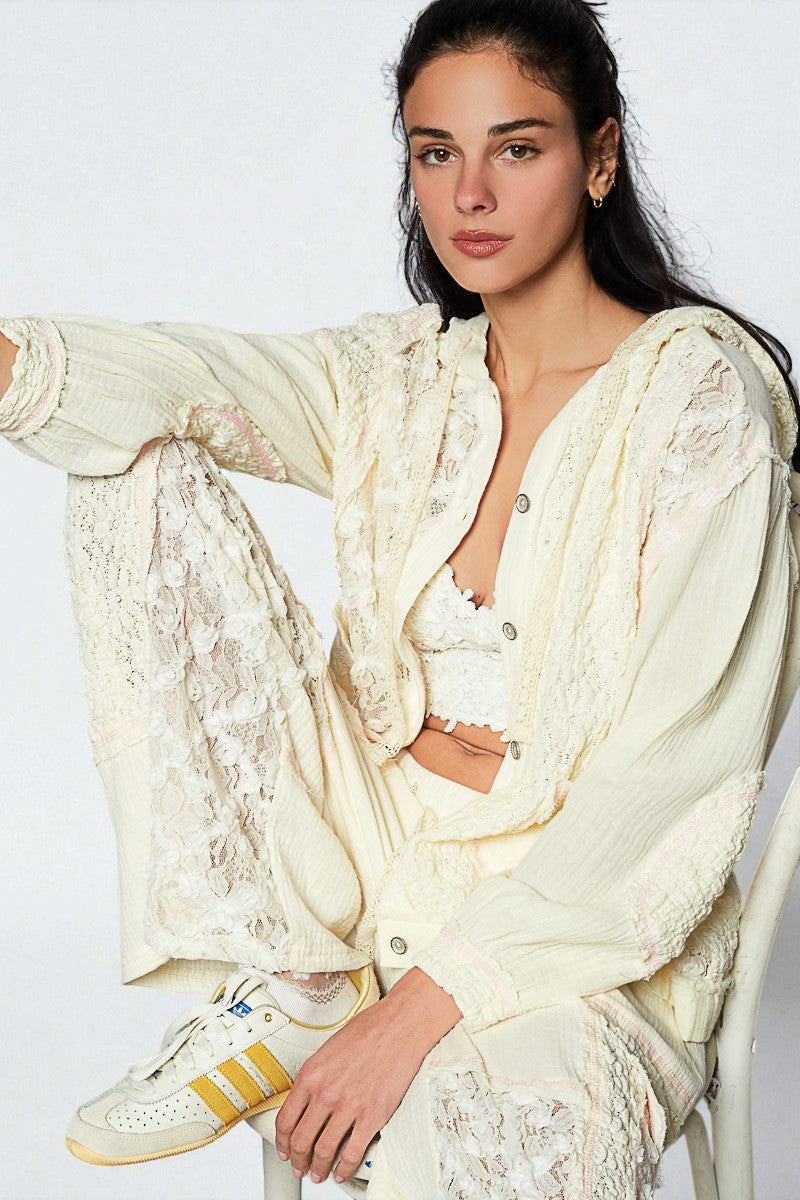 Woman wearing a white lace outfit with sneakers on a white background