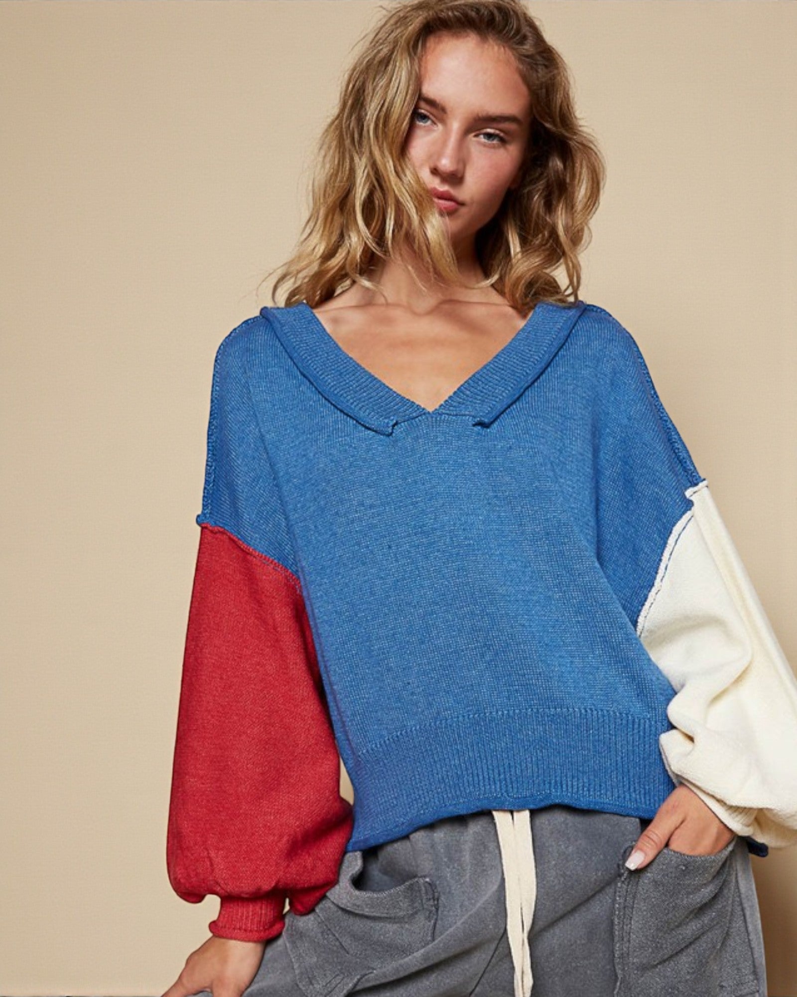 Woman wearing a colorful sweater with a neutral background