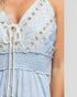 Light blue dress with floral lace details on a plain background