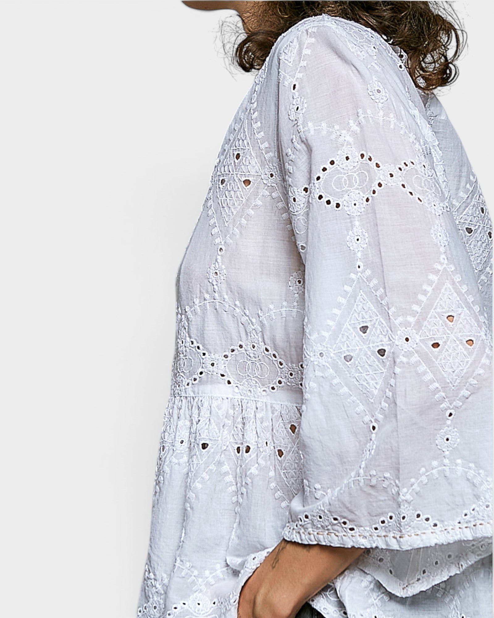 White embroidered blouse with long sleeves on a white background