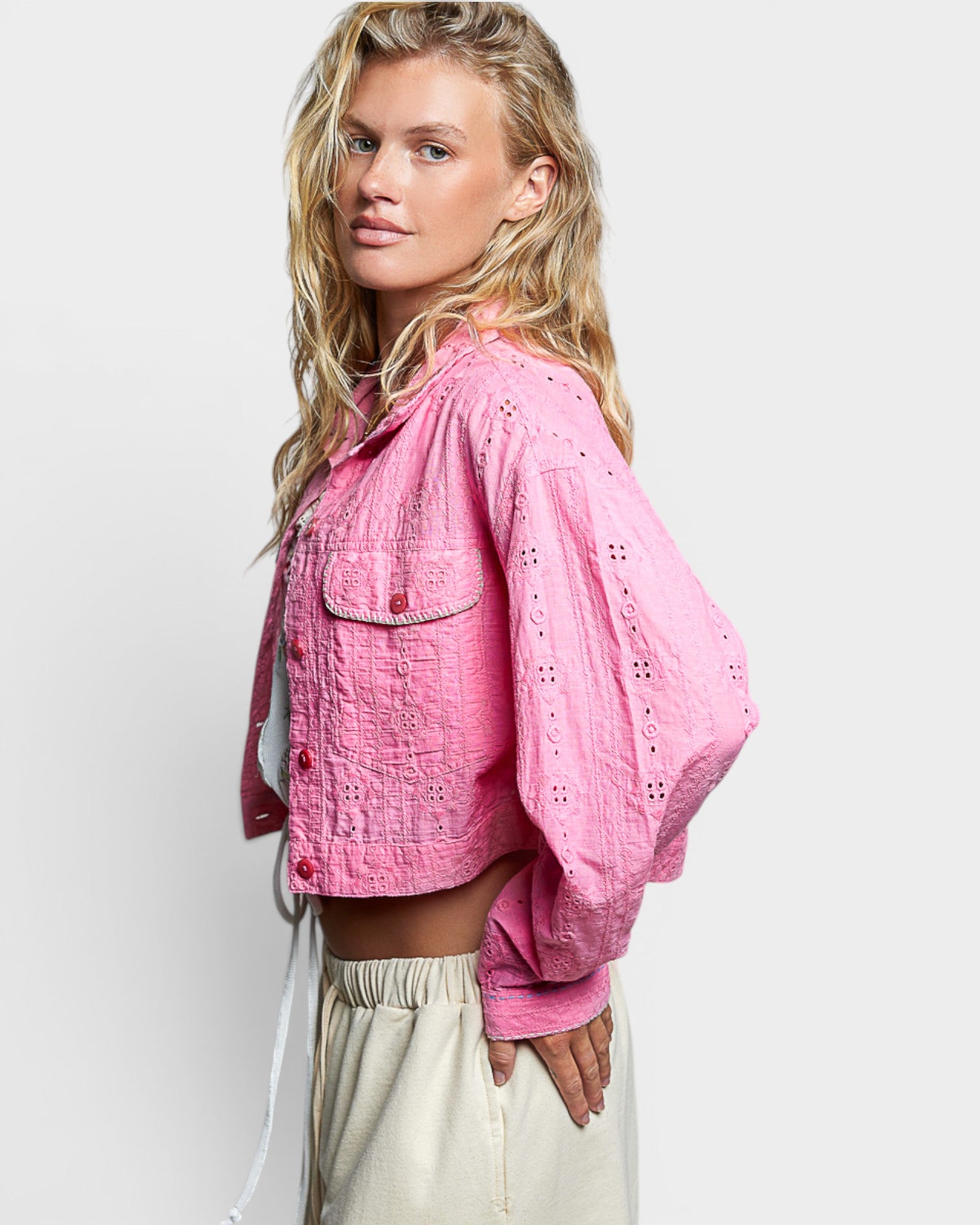 Woman wearing a pink jacket on a white background