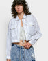 Person wearing an off white embroidered jacket and denim pants on a white background