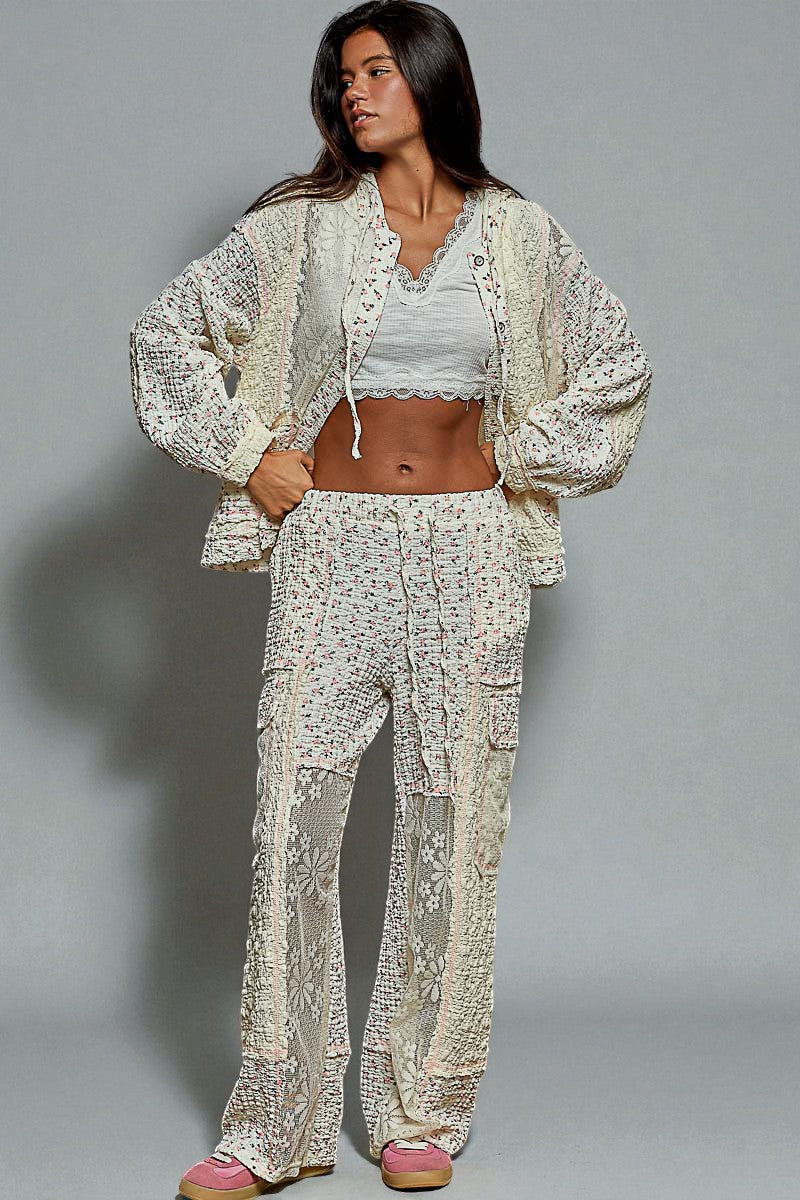 Woman wearing a patterned outfit against a gray background
