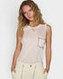 Woman wearing a light pink sleeveless top with a small graphic on a plain background