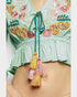 Light green embroidered top with colorful tassels on a plain background
