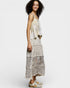 Woman wearing a patterned dress on a white background