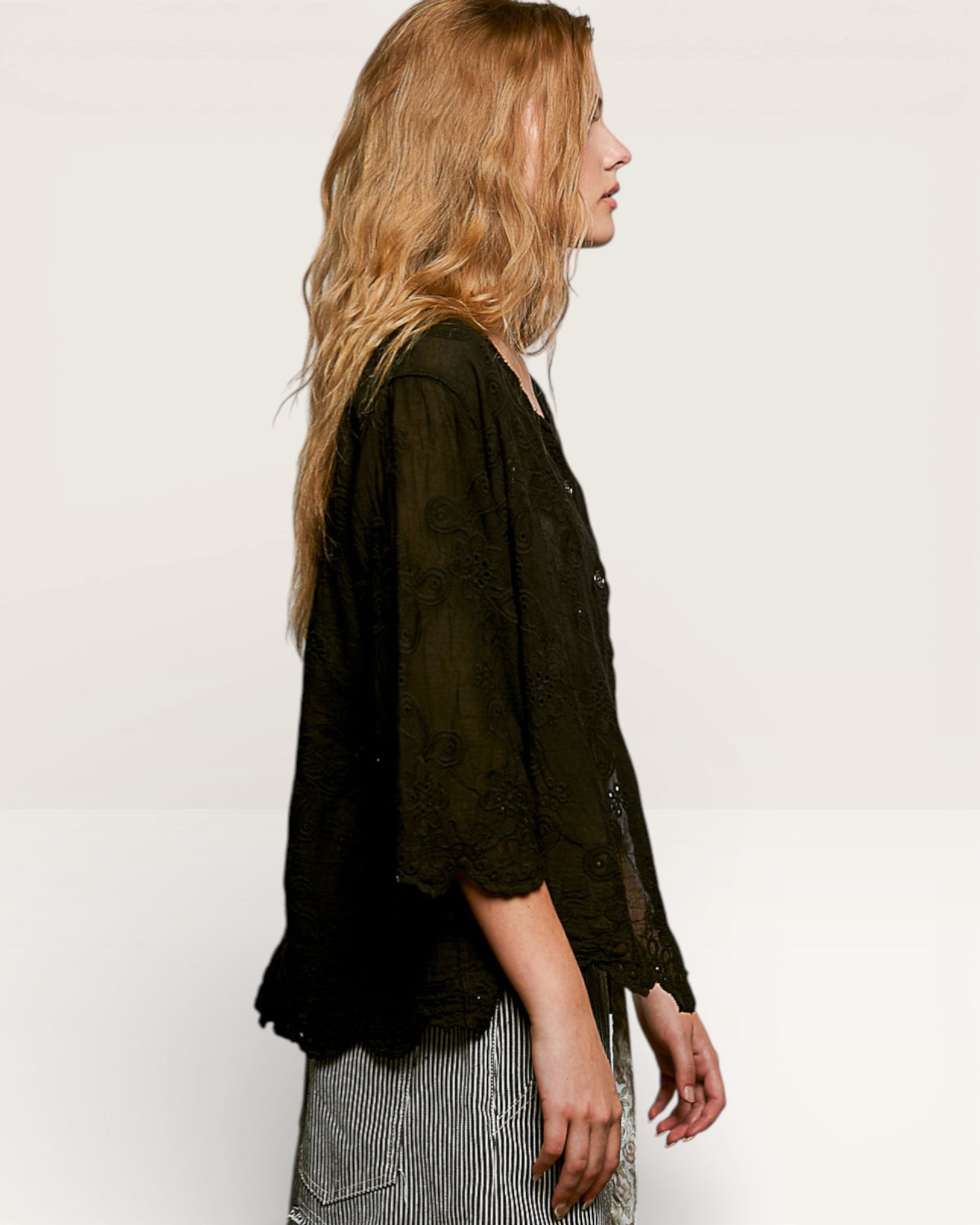 Woman wearing a black shirt with a white background